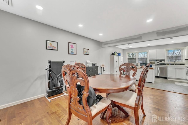 dining space with recessed lighting, visible vents, plenty of natural light, and light wood-style flooring