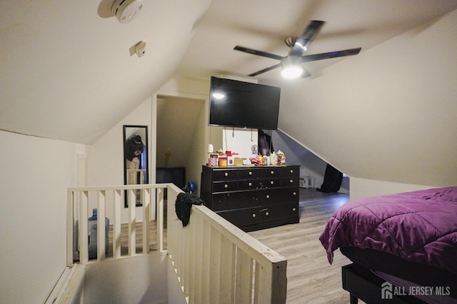 bedroom featuring a ceiling fan, lofted ceiling, and wood finished floors