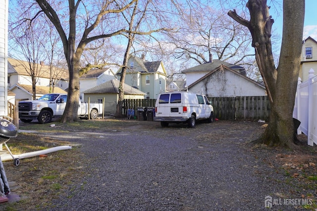 view of front of property featuring a residential view and fence