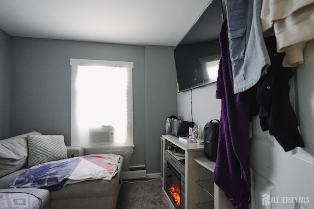 carpeted bedroom featuring a baseboard heating unit