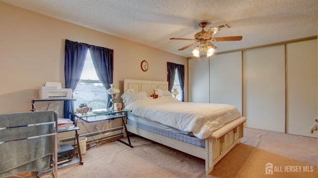 437 Belford Rd Unit B, Monroe, NJ 08831 - carpeted bedroom featuring a closet, a textured ceiling, a ceiling fan, and a baseboard radiator