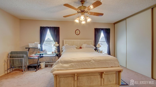 437 Belford Rd Unit B, Monroe, NJ 08831 - bedroom featuring carpet flooring, multiple windows, a closet, a textured ceiling, and a ceiling fan
