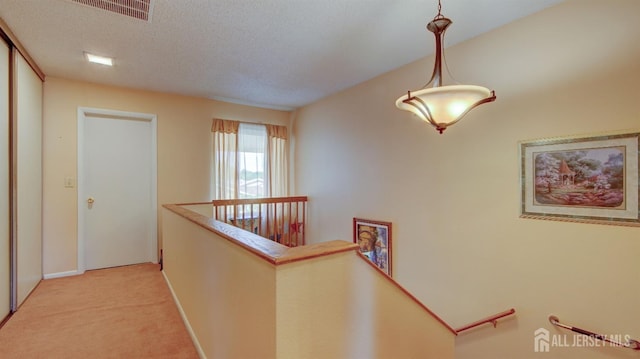437 Belford Rd Unit B, Monroe, NJ 08831 - corridor featuring an upstairs landing, light carpet, a textured ceiling, and baseboards