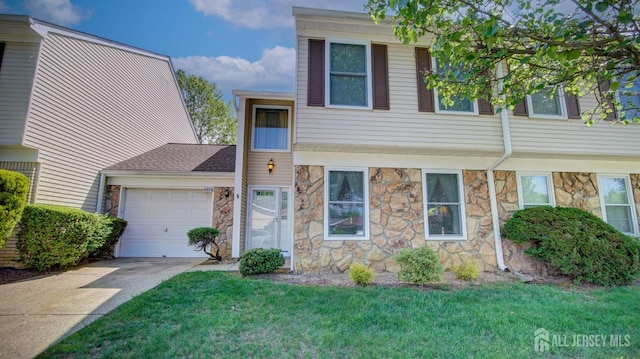 437 Belford Rd Unit B, Monroe, NJ 08831 - townhome / multi-family property with stone siding, a garage, driveway, and a front lawn