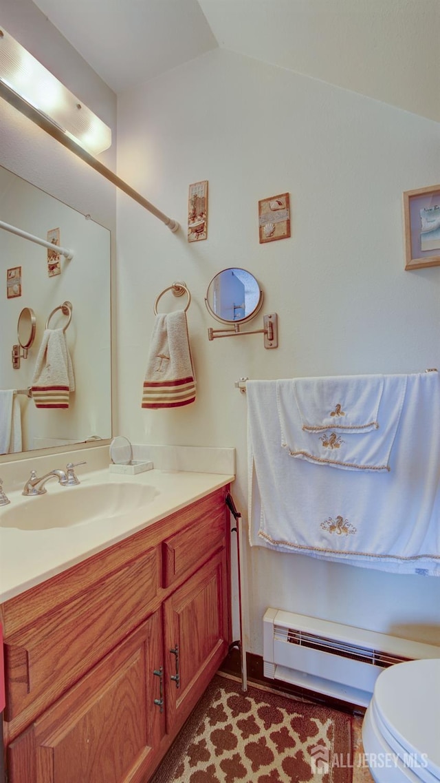 437 Belford Rd Unit B, Monroe, NJ 08831 - half bath with vanity, toilet, a baseboard heating unit, and lofted ceiling