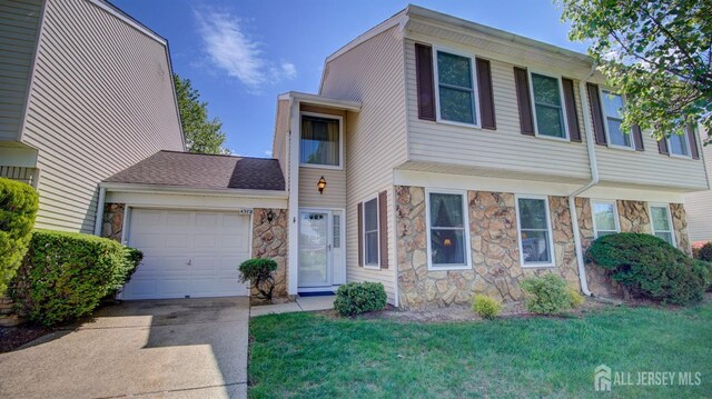 437 Belford Rd Unit B, Monroe, NJ 08831 - townhome / multi-family property featuring stone siding, a garage, driveway, and a front lawn