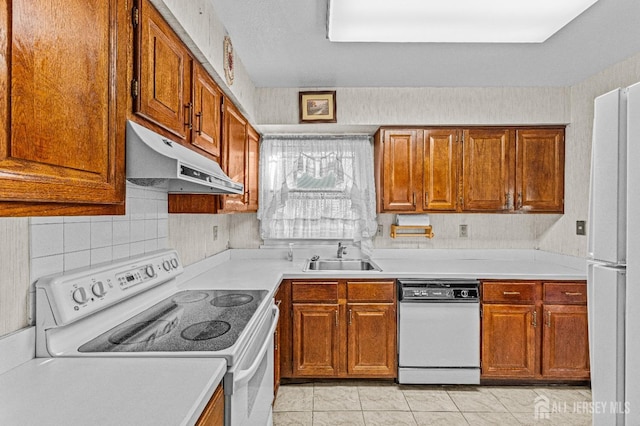 kitchen with sink, white appliances, decorative backsplash, and light tile patterned flooring