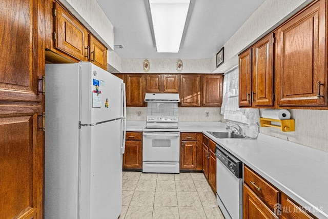 kitchen featuring backsplash, white appliances, sink, and light tile patterned floors