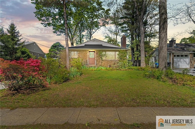 552 Parkview Ave, North Plainfield, NJ 07063 - view of front of property featuring a lawn, a chimney, and stone siding
