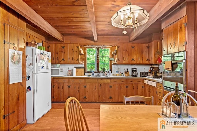 552 Parkview Ave, North Plainfield, NJ 07063 - kitchen with white appliances, brown cabinets, a chandelier, light wood finished floors, and wood ceiling with exposed beams