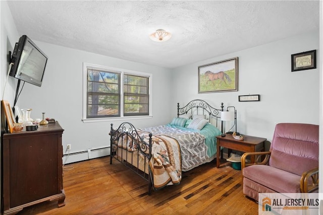552 Parkview Ave, North Plainfield, NJ 07063 - bedroom featuring baseboard heating, wood finished floors, and a textured ceiling