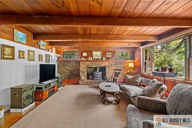 552 Parkview Ave, North Plainfield, NJ 07063 - living room featuring wooden ceiling with exposed beams, wood finished floors, a wood stove, and wood walls
