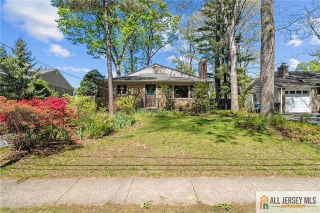 552 Parkview Ave, North Plainfield, NJ 07063 - view of front of house featuring a front yard, a chimney, stone siding, and an attached garage