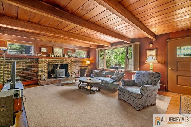 552 Parkview Ave, North Plainfield, NJ 07063 - living room with wooden ceiling with exposed beams, a wood stove, wooden walls, and wood finished floors