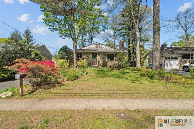 552 Parkview Ave, North Plainfield, NJ 07063 - view of front of property featuring a front yard, a chimney, and an attached garage