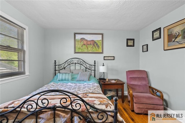 552 Parkview Ave, North Plainfield, NJ 07063 - bedroom with wood finished floors and a textured ceiling