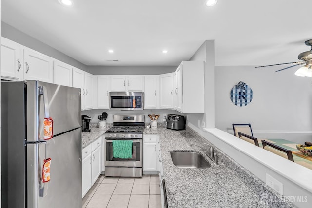 2207 Timber Ridge Ct, Sayreville, NJ 08859 - kitchen featuring appliances with stainless steel finishes, ceiling fan, white cabinets, recessed lighting, and light stone counters