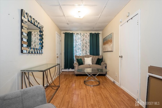 719 Catherine St, Perth Amboy, NJ 08861 - living area featuring wood finished floors, a drop ceiling, and baseboards