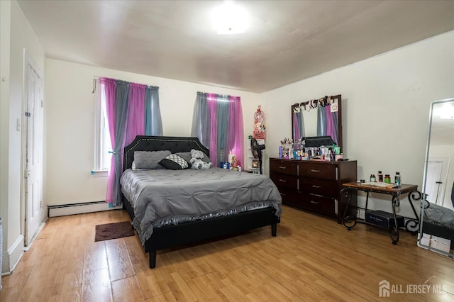 719 Catherine St, Perth Amboy, NJ 08861 - bedroom featuring a baseboard heating unit and light wood finished floors