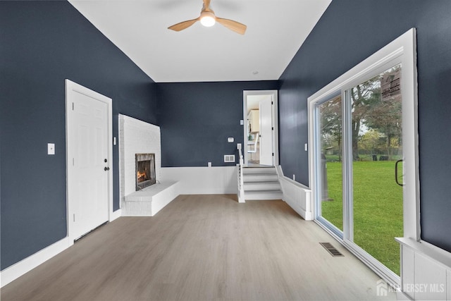 344 W Point Ave W, Franklin Twsp, NJ 08873 - unfurnished living room with a ceiling fan, visible vents, a fireplace, wainscoting, and wood finished floors