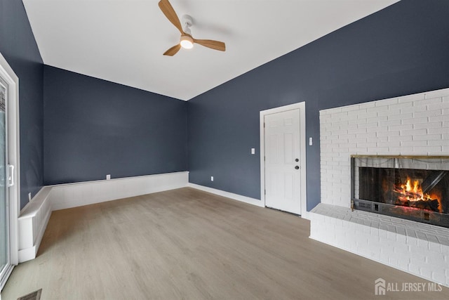 344 W Point Ave W, Franklin Twsp, NJ 08873 - unfurnished living room featuring ceiling fan, visible vents, a fireplace, vaulted ceiling, and wood finished floors