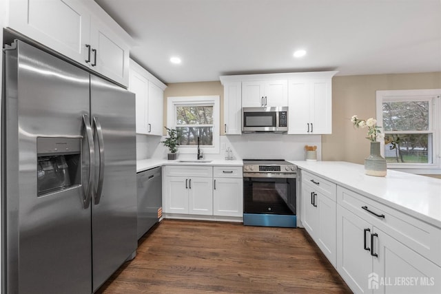 344 W Point Ave W, Franklin Twsp, NJ 08873 - kitchen with dark wood-type flooring, light countertops, white cabinets, a sink, and appliances with stainless steel finishes