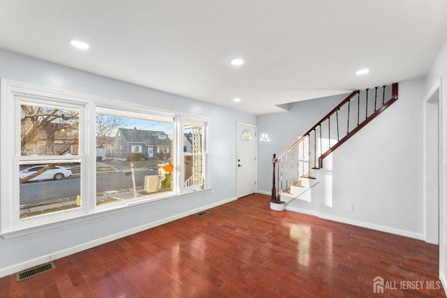 foyer featuring stairway, wood finished floors, visible vents, baseboards, and recessed lighting