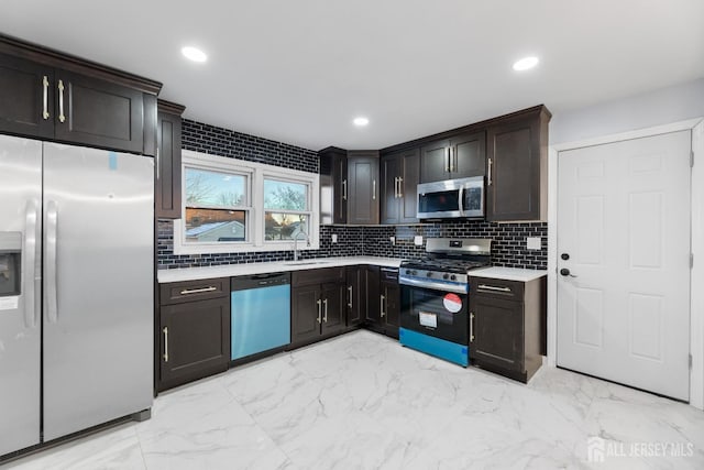 kitchen with backsplash, dark brown cabinetry, sink, and appliances with stainless steel finishes