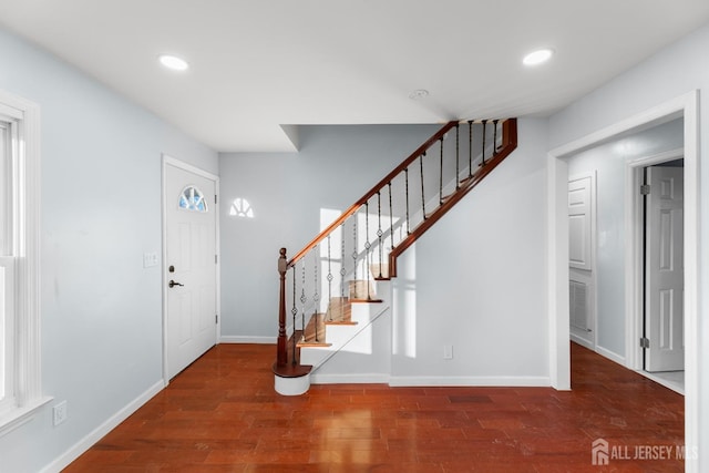 entryway with stairway, recessed lighting, and wood finished floors