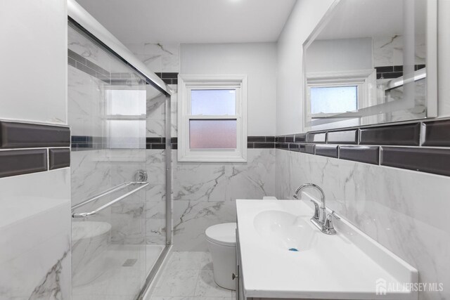 bathroom with a wealth of natural light, a shower with door, toilet, and tile walls