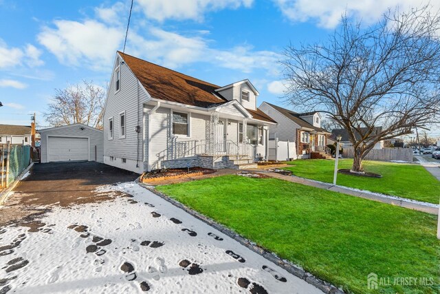 view of front of home with a front yard, an outdoor structure, and a garage