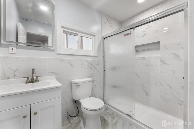 bathroom with vanity, a shower stall, toilet, and marble finish floor