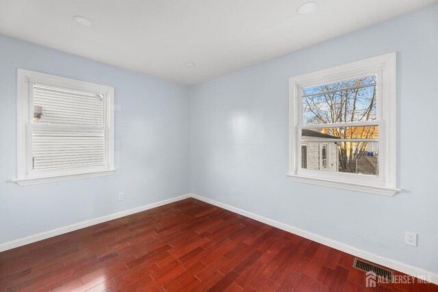 spare room featuring dark hardwood / wood-style floors