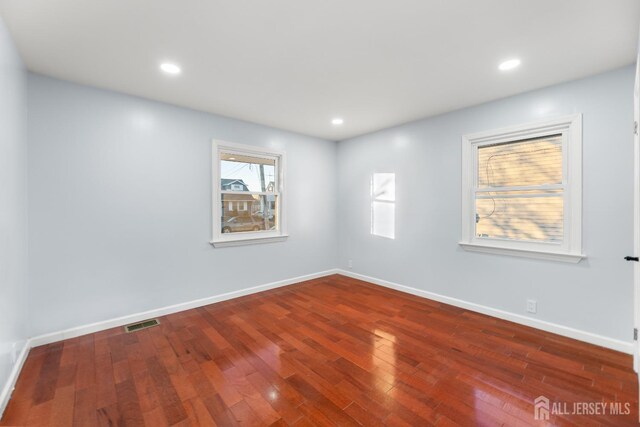 spare room featuring dark wood-type flooring