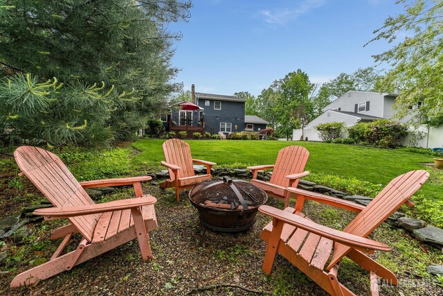 14 Bonnie Brook Ter, Middlesex, NJ 08846 - view of green lawn with an outdoor fire pit and a wooden deck