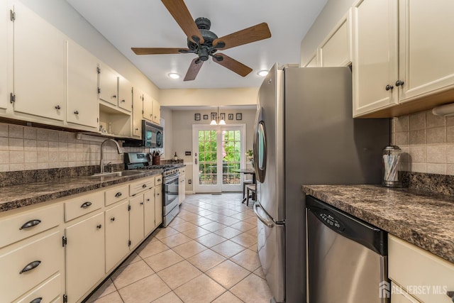 14 Bonnie Brook Ter, Middlesex, NJ 08846 - kitchen with stainless steel appliances, a sink, a ceiling fan, dark countertops, and light tile patterned floors