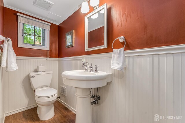 14 Bonnie Brook Ter, Middlesex, NJ 08846 - half bathroom with wood finished floors, a wainscoted wall, toilet, and ornamental molding