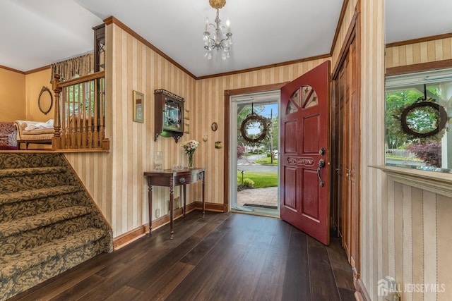 14 Bonnie Brook Ter, Middlesex, NJ 08846 - entrance foyer featuring dark wood finished floors, a chandelier, wallpapered walls, crown molding, and baseboards