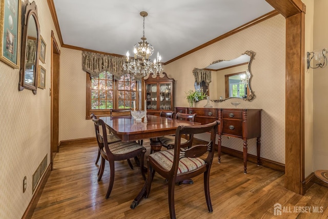 14 Bonnie Brook Ter, Middlesex, NJ 08846 - dining space with wallpapered walls, crown molding, wood finished floors, a chandelier, and baseboards