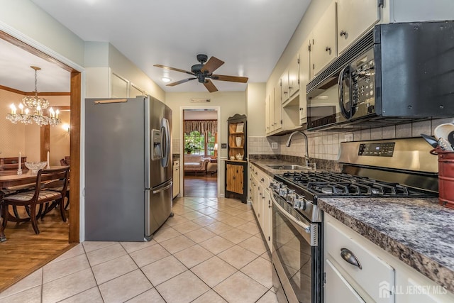 14 Bonnie Brook Ter, Middlesex, NJ 08846 - kitchen with appliances with stainless steel finishes, a sink, dark countertops, ceiling fan, and a chandelier