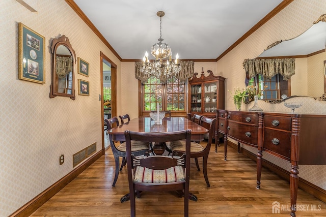 14 Bonnie Brook Ter, Middlesex, NJ 08846 - dining room with wood finished floors, ornamental molding, wallpapered walls, and a chandelier