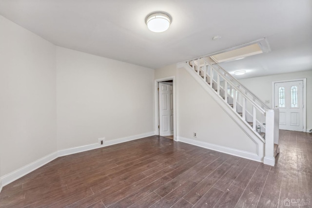 interior space featuring stairway, dark wood-style floors, and baseboards