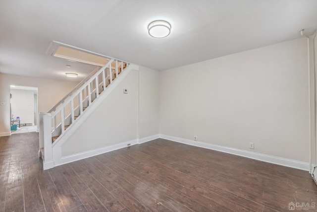 interior space with stairs, baseboards, and dark wood-style flooring