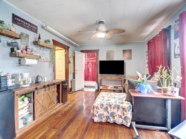 381 Keene St, Perth Amboy, NJ 08861 - living room featuring a ceiling fan, wood-type flooring, radiator, beverage cooler, and ornamental molding