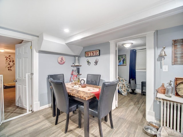 381 Keene St, Perth Amboy, NJ 08861 - dining space with light wood-type flooring and radiator