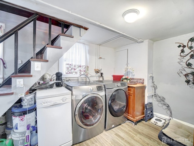 381 Keene St, Perth Amboy, NJ 08861 - laundry room featuring light wood finished floors, washer and clothes dryer, and cabinet space