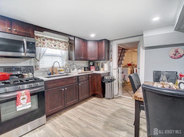 381 Keene St, Perth Amboy, NJ 08861 - kitchen with appliances with stainless steel finishes, light countertops, decorative backsplash, light wood-style flooring, and recessed lighting