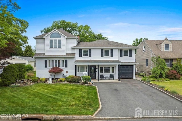 660 Summit Ave, Kenilworth, NJ 07033 - split level home with an attached garage, asphalt driveway, a front lawn, a porch, and a shingled roof