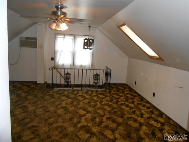 bonus room featuring an AC wall unit, lofted ceiling, carpet floors, and ceiling fan