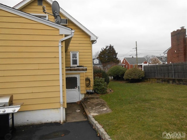 view of side of property with a lawn